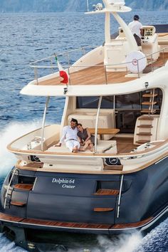 two people sitting on the back of a boat