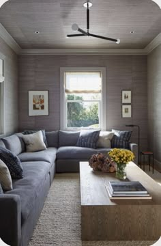 a living room filled with furniture and a flat screen tv mounted to the side of a wall