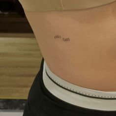 the back of a woman's stomach with writing on it