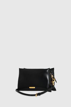 This crossbody bag combines a sleek black silhouette with playful heart-shaped stud patterns in gold-tone detailing. Compact yet roomy enough for your essentials, it features an adjustable strap for versatility and a zipper closure to keep everything secure. It's the perfect accessory to add a touch of charm with a little edge. Style # SH24TRTXBO-BLACK 100% Faux Leather Antique Brass Hardware 9. 5" W x 5. 625" H x 1. 5" D 21. 63" Strap Drop Zipper Closure 1 Back Pocket Chainlink Jacquard Lining Antique Brass Hardware, Black Silhouette, Heart Studs, Brass Hardware, Rebecca Minkoff, Chain Link, Antique Brass, Crossbody Bag, Adjustable Straps