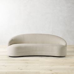 a white couch sitting on top of a wooden floor