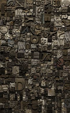 an image of many different type of letters and numbers on a wall that is made out of metal