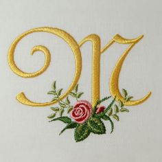 the number nine is decorated with flowers and leaves on a white background, as well as gold lettering