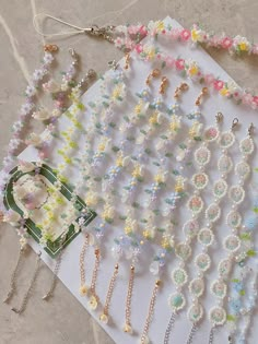 several necklaces are laid out on the floor next to each other, including pearls and beads