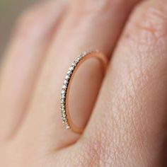 a woman's hand with a diamond ring on it