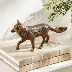 a figurine of a fox on top of a book