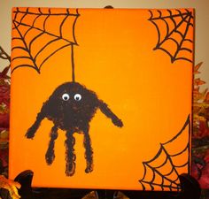 an orange halloween canvas with a spider on it