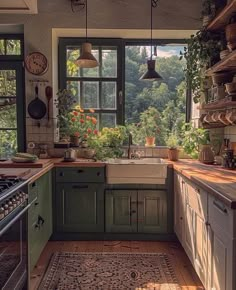 a kitchen filled with lots of green cupboards and counter top space next to a window