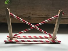 a pair of red and white striped barricades sitting on top of a table