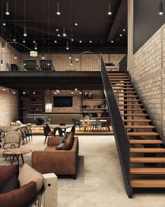 an open concept living room with stairs leading up to the second floor and dining area