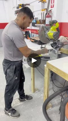 a man using a circular saw to cut wood with a power tool on a workbench