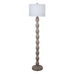 a floor lamp with a white shade on the top and bottom part of it's base