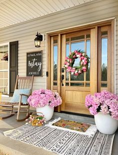 the front porch is decorated with pink flowers