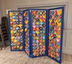 a room divider made out of candy bar wrappers and blue paint on it