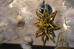 an ornament hanging from a white christmas tree