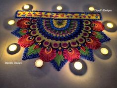 an intricately decorated diya with lit candles