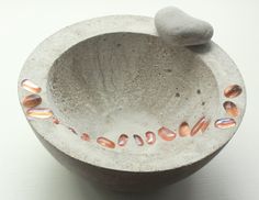 a stone bowl with some rocks in it