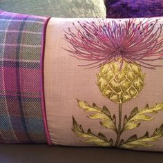 a pink and purple pillow sitting on top of a table