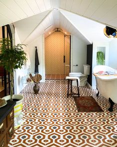 a bathroom with an orange and white patterned floor