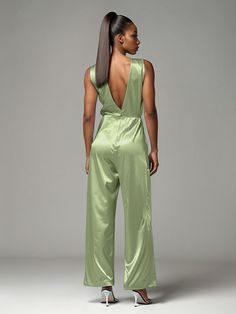 This soft satin jumpsuit features a flattering v-neck design, making it the perfect choice for mothers of the bride. Its dress pantsuit style provides comfort and elegance, while its high-quality material ensures a polished look. Stay stylish and comfortable on that special day with our jumpsuit. Satin Jumpsuit With V-neck For Party, Satin V-neck Jumpsuit For Party, Green V-neck Jumpsuit For Loungewear, Chic Green V-neck Jumpsuit, Green V-neck Cotton Jumpsuit, Satin Jumpsuit, Peacock Green, Dress With Tie, Stylish Wedding