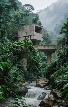 a river flowing under a bridge surrounded by lush green trees and rocks in front of a tall building