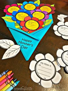 mother's day craft with flowers and crayons on the table next to it