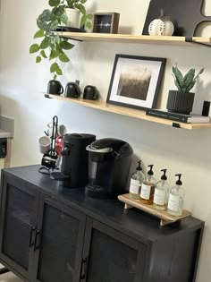 a coffee maker on top of a black cabinet