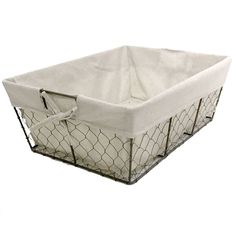 a chicken wire basket with a white cover on it's sides and handles, is shown in front of a white background