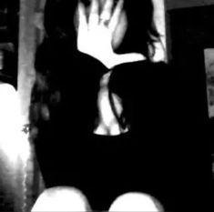 black and white photograph of a woman covering her face