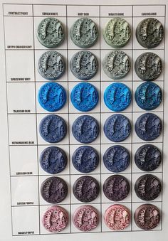 an image of different colored coins on a white board with black and blue circles in the middle