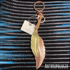 a gold leaf keychain with a tag attached to it