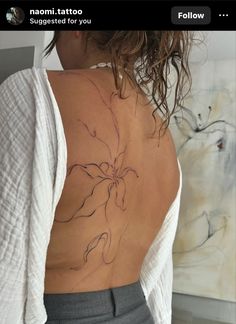 a woman with a tattoo on her back