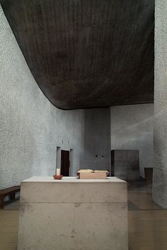 the interior of a modern building with concrete walls