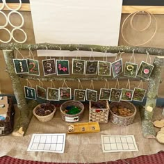 a table topped with pictures and baskets filled with plants on top of a cloth covered floor