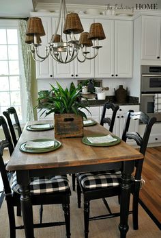 a dining room table with place settings on it