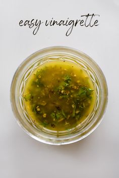 an overhead view of a small glass bowl filled with olives and herbs, next to the words easy unaigritette