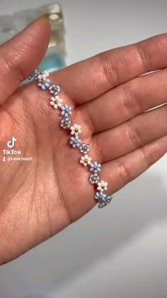 a person holding out their hand with some beads on it