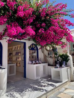 a white building with purple flowers on the outside