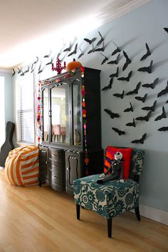 a living room filled with furniture and lots of bats on the wall