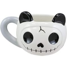 a white ceramic mug with black ears and eyes