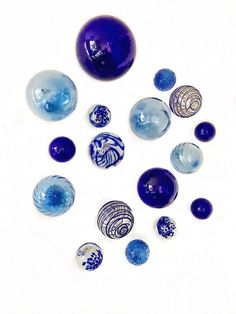 blue and white glass balls on a white surface