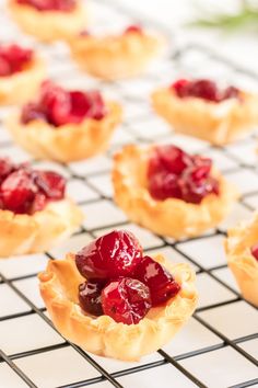 small cranberry tarts on a cooling rack ready to go into the oven