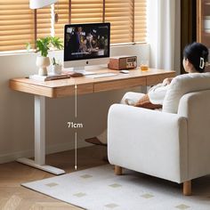 a woman sitting at a desk with a computer on it and measurements for the chair