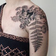 a woman's chest with flowers and leaves on it