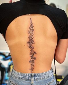 the back of a woman's lower back tattoo