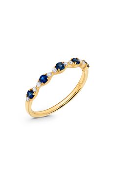 a yellow gold ring with blue and white stones on the side, set in 18k gold