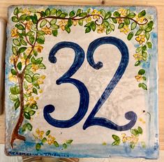 a blue and white ceramic sign with the number twenty two on it's side