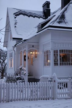 a white house with snow on the roof