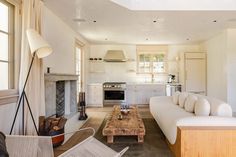 a living room filled with furniture and a fire place