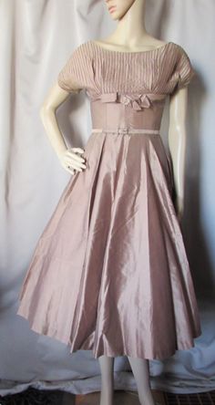 "SALE! 15% OFF! Amazing 1960 Era Full Skirted Dress. The color is a cocoa in a cotton with sheen-so we will call it polished cotton. Appropriate for special day time occasions, it could also translate well for cocktail events. The bodice features a \"yoke\" that is pin-tucked and includes the 7\" raglan sleeves. The waist is empire with an encircling band highlighted with a front bow. The torso is very small indeed (note we could not close zipper on the model). At the natural waist is a 1/2 x 28 1950 Style, Knitted Winter Dress, 1960 Style, 1960 Dress, 1950 Fashion, Dress And Jacket Set, Black Knit Top, Full Skirt Dress, Lounge Dress